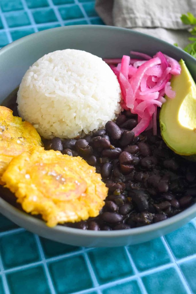 Bean menestra served with rice, onions, avocado and plantains. 