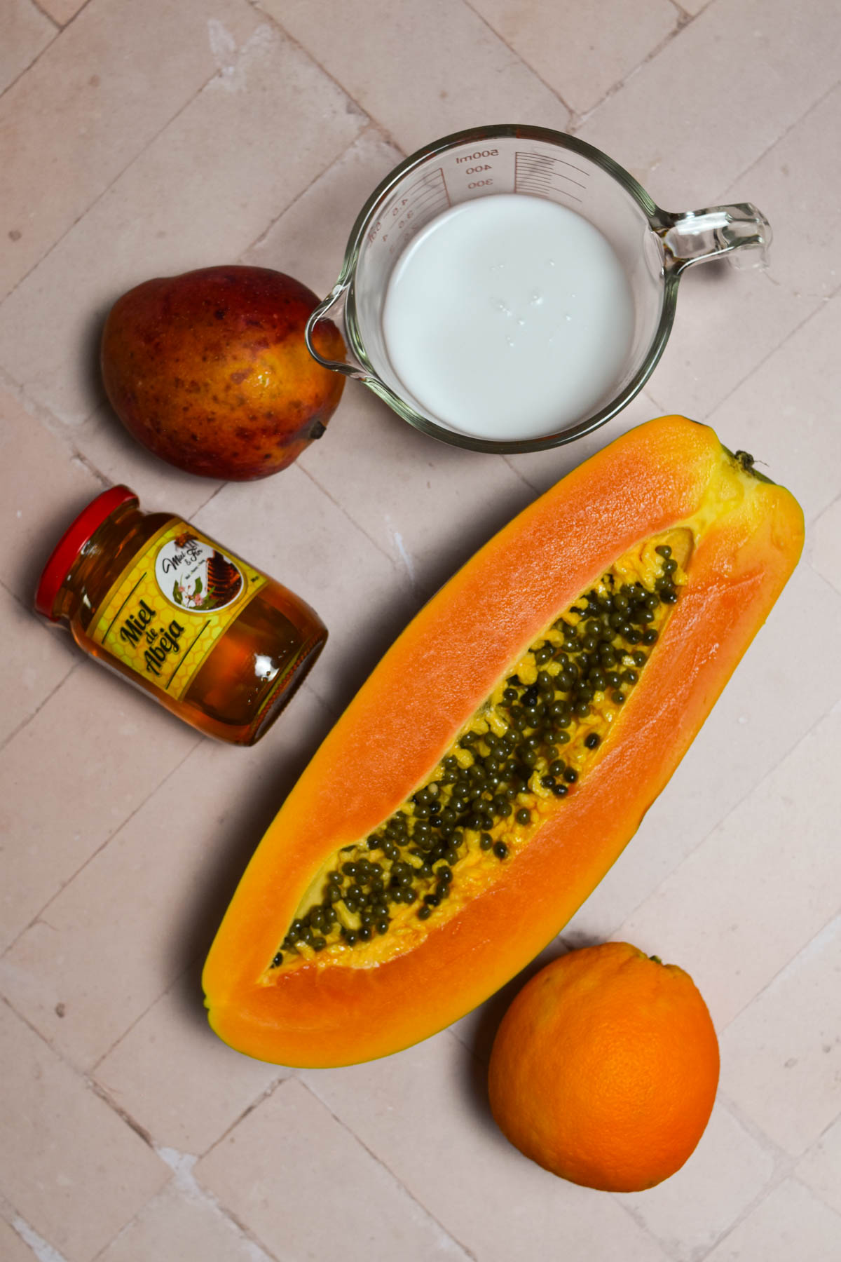 Overhead shot of ingredients needed for papaya mango smoothie. 