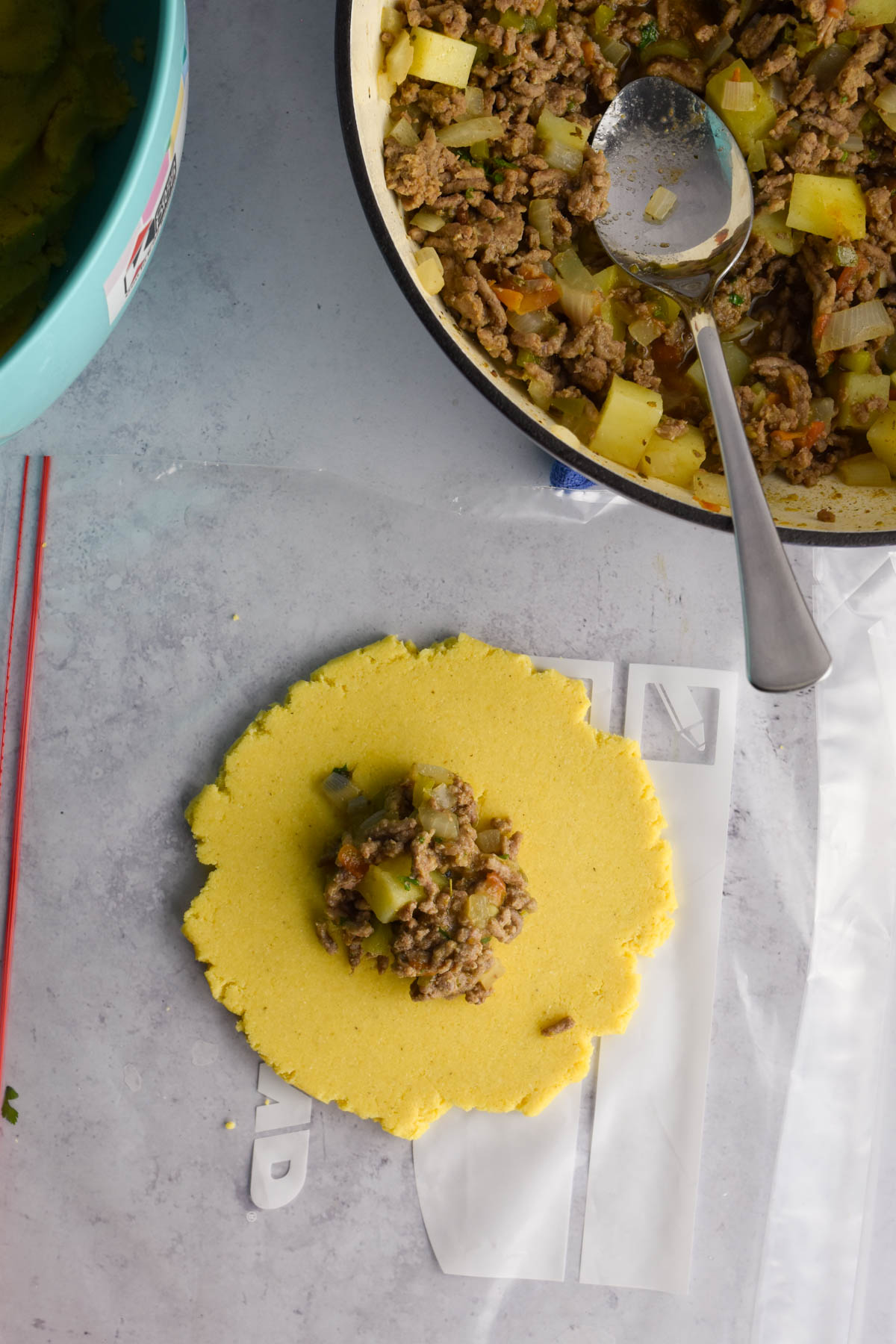 Empanada dough disk with filling in the middle. 