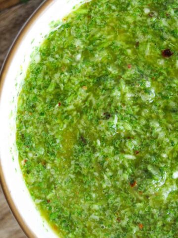 Close up shot of cilantro chimichurri in a small bowl.