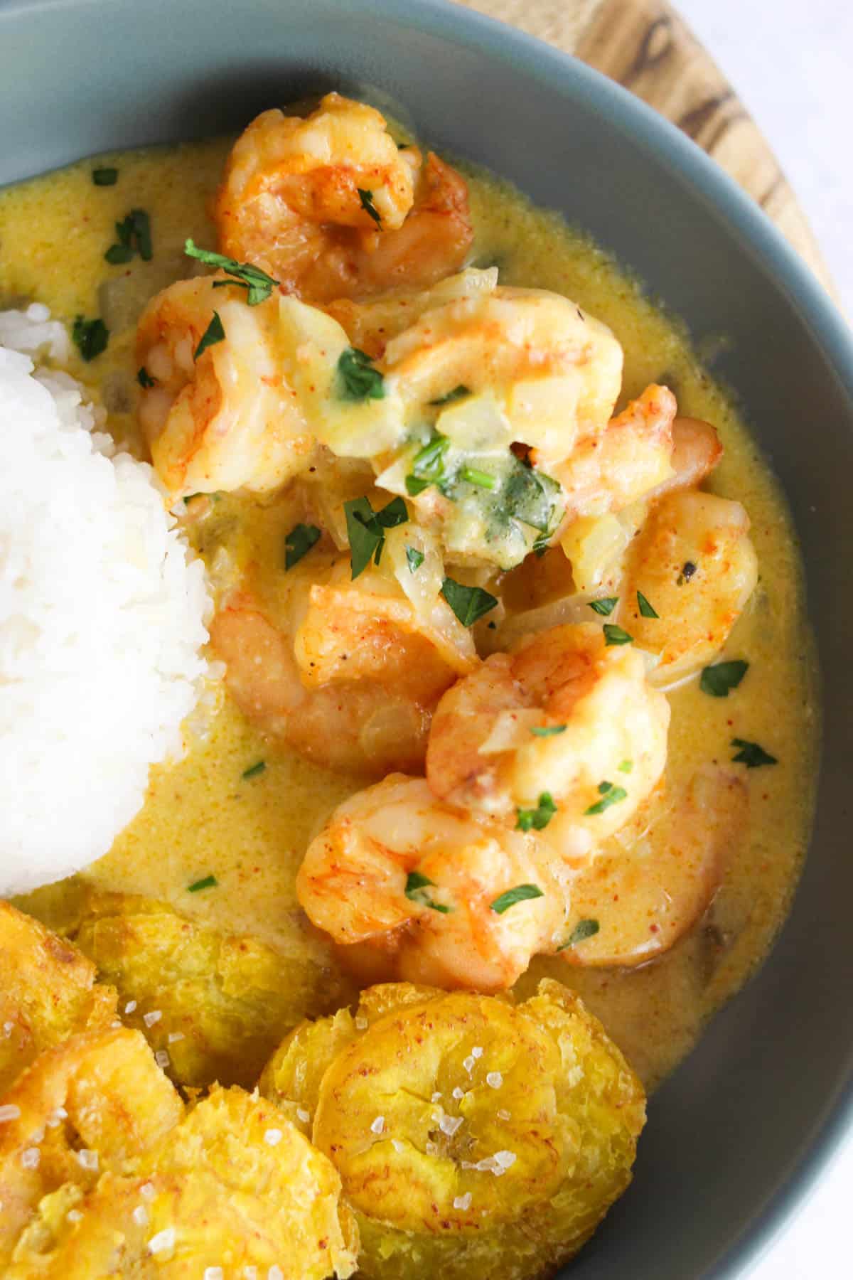 Close up shot of garlic shrimp with parsley on top.