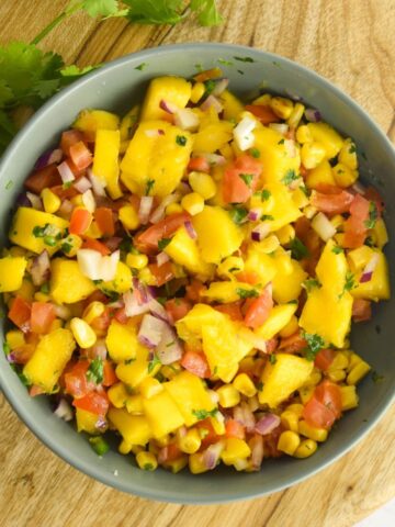 Overhead shot of corn mango salsa in a bowl.