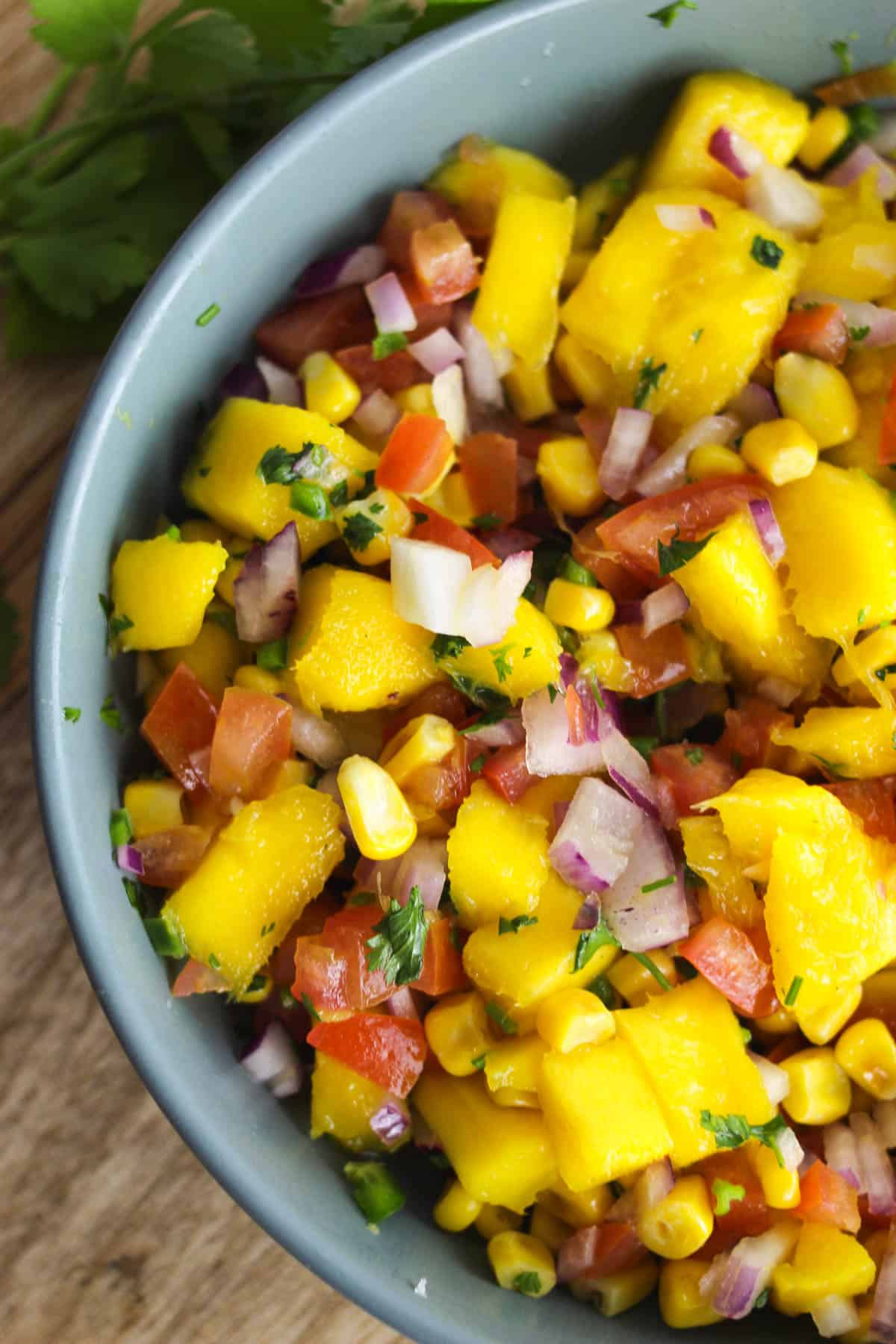 Close up shot of corn mango salsa in a bowl.